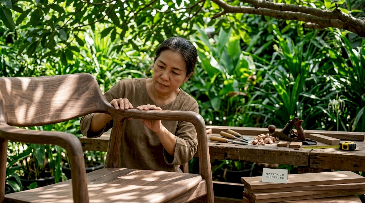 Craftswoman inspecting handmade wooden chair