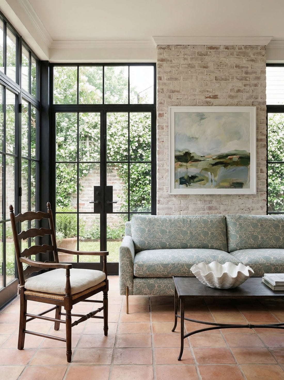 Floral sofa in a neutral sunroom with breathing room around it