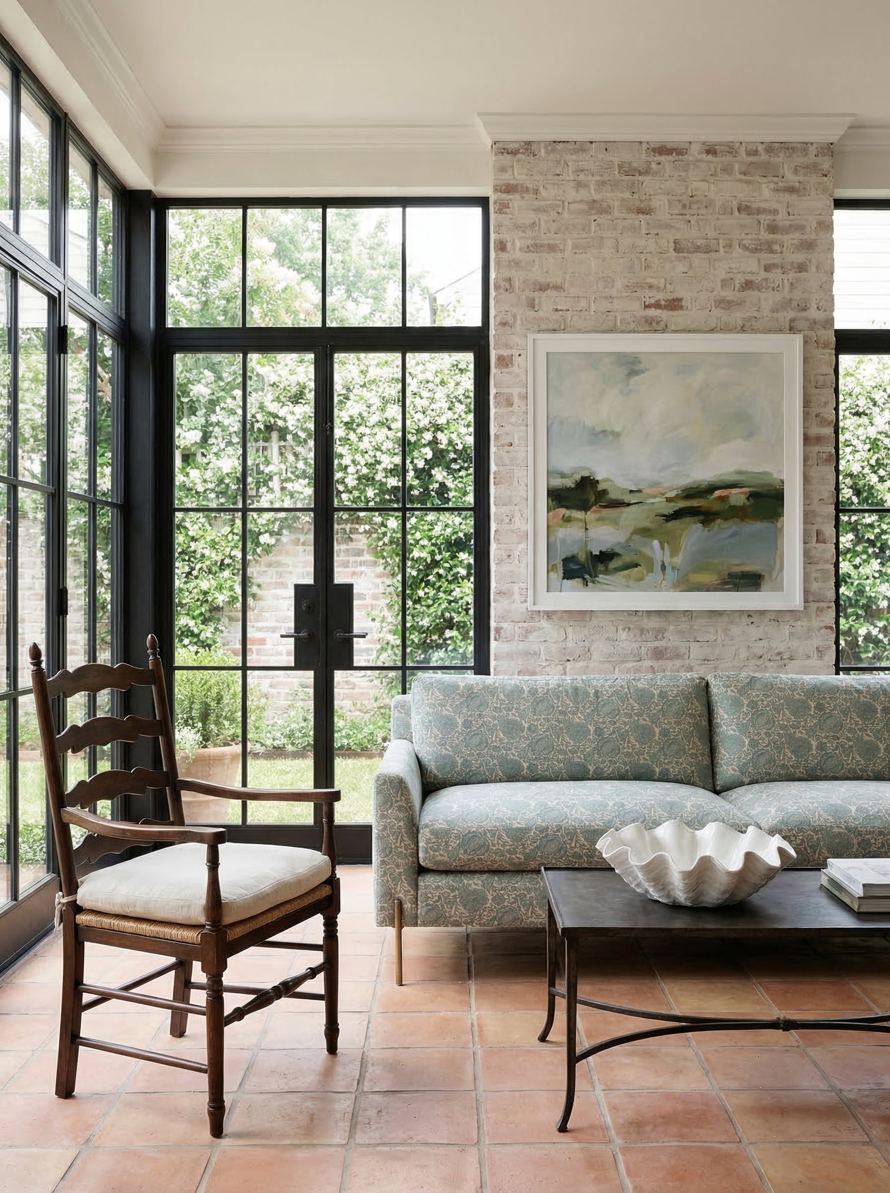 Floral sofa in a neutral sunroom with breathing room around it